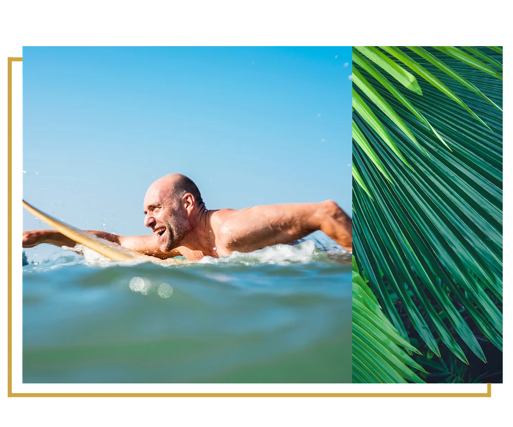 older man surfing happily